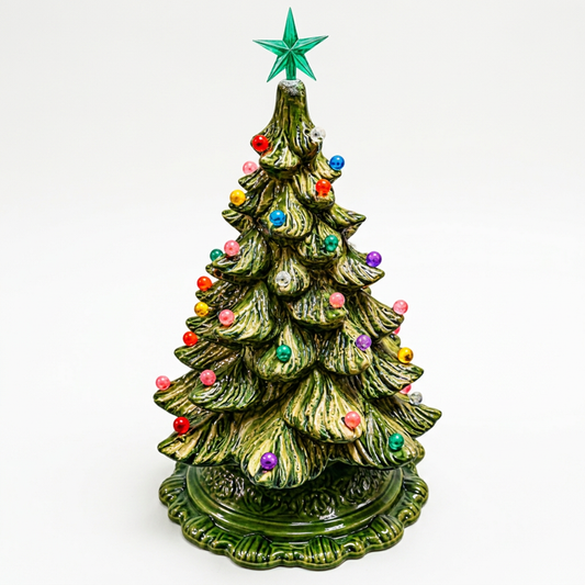 Ceramic tree with lights and ornaments on soft white background